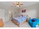 Well-lit bedroom with ensuite bathroom access and ceiling fan at 12710 Sorrento Way # 101, Bradenton, FL 34211