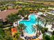 Aerial view of resort-style pool with lounge chairs and palm trees at 12710 Sorrento Way # 101, Bradenton, FL 34211