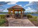 Charming gazebo with lake view and brick path at 12710 Sorrento Way # 101, Bradenton, FL 34211
