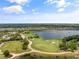 Aerial view of golf course and lake with homes at 12710 Sorrento Way # 101, Bradenton, FL 34211