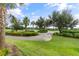 Landscaped path meanders through lush green golf course at 12710 Sorrento Way # 101, Bradenton, FL 34211