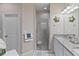 Clean bathroom with walk-in shower, granite countertop, and storage at 12710 Sorrento Way # 101, Bradenton, FL 34211