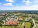 Aerial view of community with clubhouse, pool, golf course, and numerous homes at 12710 Sorrento Way # 101, Bradenton, FL 34211