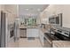 Bright kitchen featuring stainless steel appliances and granite countertops at 12710 Sorrento Way # 101, Bradenton, FL 34211
