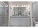 Modern bathroom with double vanity, granite countertop, and walk-in shower at 12710 Sorrento Way # 101, Bradenton, FL 34211