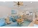 Bright and airy living room with comfortable seating and a large window at 12710 Sorrento Way # 101, Bradenton, FL 34211