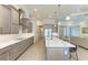 Modern kitchen featuring a large island and hardwood floors at 405 Maraviya Blvd, Nokomis, FL 34275