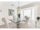 Dining area with a glass table and four beige chairs at 1156 Palmetto Dr, Venice, FL 34293