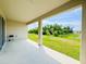 Covered back patio with view of the backyard and green space at 10827 Charlotte Dr, Parrish, FL 34219