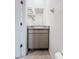A half bath with granite countertops, gray cabinets, and modern shelving at 10827 Charlotte Dr, Parrish, FL 34219