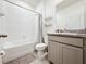 A full bathroom featuring a tub and shower, granite countertops, and shelving at 10827 Charlotte Dr, Parrish, FL 34219