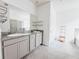Bright bathroom featuring double sinks, granite countertops, and modern fixtures with a tile floor at 10827 Charlotte Dr, Parrish, FL 34219