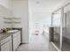 Modern bathroom featuring double sink vanity, walk-in shower, and tiled floors at 10827 Charlotte Dr, Parrish, FL 34219
