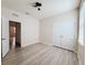 A bedroom with light wood-look flooring, a ceiling fan and double closet doors at 10827 Charlotte Dr, Parrish, FL 34219