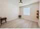 Well-lit bedroom with wood-look flooring, a ceiling fan and a window for natural light at 10827 Charlotte Dr, Parrish, FL 34219