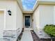 Inviting home entrance with a covered porch and decorative stone accents at 10827 Charlotte Dr, Parrish, FL 34219