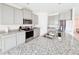 Bright kitchen with large island, granite countertops, stainless steel appliances, and ample cabinetry at 10827 Charlotte Dr, Parrish, FL 34219