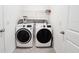 A laundry room featuring a new washer and dryer, as well as shelving for storage at 10827 Charlotte Dr, Parrish, FL 34219