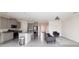 Open-concept layout showcasing kitchen with a bar and living area with neutral tile floors at 10827 Charlotte Dr, Parrish, FL 34219