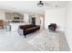 Open-concept kitchen and living area with modern furniture and neutral ceramic tile floors at 10827 Charlotte Dr, Parrish, FL 34219