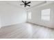 Bright and airy bedroom with wood floors, and three windows at 10827 Charlotte Dr, Parrish, FL 34219