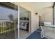 Cozy balcony with seating and a view of the beach and ocean, seamlessly connecting to the living area at 19 Whispering Sands Dr # 204, Sarasota, FL 34242
