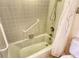Bathroom with shower and tub featuring safety grab bar at 19 Whispering Sands Dr # 204, Sarasota, FL 34242