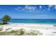 Scenic beach featuring clear turquoise water, white sand, and blue skies, perfect for relaxation at 19 Whispering Sands Dr # 204, Sarasota, FL 34242