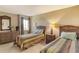 Bright bedroom featuring twin beds, a dresser, a nightstand, and a window at 19 Whispering Sands Dr # 204, Sarasota, FL 34242