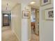 Hallway leading to a bedroom with an opening showcasing a nicely decorated room at 19 Whispering Sands Dr # 204, Sarasota, FL 34242
