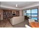 Inviting lounge area with bookshelves, TV, and ocean views by the pool at 19 Whispering Sands Dr # 204, Sarasota, FL 34242