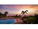 Scenic sunset view of the beachfront pool and palm trees at 19 Whispering Sands Dr # 204, Sarasota, FL 34242