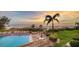 Beautiful pool area with lush tropical landscaping and ocean views, perfect for relaxation and enjoyment at 19 Whispering Sands Dr # 204, Sarasota, FL 34242