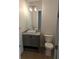 Modern bathroom with gray vanity, vessel sink, and hardwood floors at 4819 Higel Rd, Sarasota, FL 34242