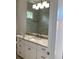 Bathroom with vanity, quartz countertop, and large mirror at 4819 Higel Rd, Sarasota, FL 34242
