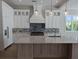 Spacious kitchen with white cabinets, large island, and modern appliances at 4819 Higel Rd, Sarasota, FL 34242