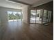 Living area with hardwood floors, sliding glass doors and pool view at 4819 Higel Rd, Sarasota, FL 34242