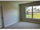 Light-filled carpeted bedroom with a large window offering views of the outdoors at 4865 Manila Ave, North Port, FL 34288