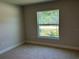 A comfortable carpeted bedroom with a view of the outdoors at 4865 Manila Ave, North Port, FL 34288