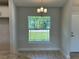 The dining area has ceramic tile floors and a large window with a view of the front yard at 4865 Manila Ave, North Port, FL 34288