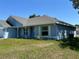 A side view of the light blue, one-story home with off white trim and a well-maintained lawn at 4865 Manila Ave, North Port, FL 34288