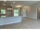 Open-concept kitchen with granite countertops and white cabinets overlooking the dining area with ceramic tile floors at 4865 Manila Ave, North Port, FL 34288