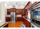 Kitchen boasts stainless steel appliances and rich wood cabinets at 17812 Doe Creek Ct, Parrish, FL 34219