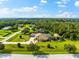 Aerial view of a house and neighborhood with a lake at 17812 Doe Creek Ct, Parrish, FL 34219