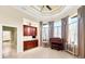 Sunroom with built-in wooden cabinets, large windows and hardwood floors at 17812 Doe Creek Ct, Parrish, FL 34219