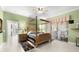 Large bedroom with a four-poster bed and access to a private bathroom at 17812 Doe Creek Ct, Parrish, FL 34219