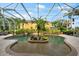 Relaxing pool area with lush landscaping and covered patio at 17812 Doe Creek Ct, Parrish, FL 34219