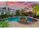 Romantic pool area at sunset with string lights at 17812 Doe Creek Ct, Parrish, FL 34219