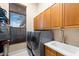 Laundry room with washer, dryer, and cabinets at 17812 Doe Creek Ct, Parrish, FL 34219