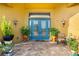 Inviting entryway with double doors, flanked by lush potted plants at 17812 Doe Creek Ct, Parrish, FL 34219